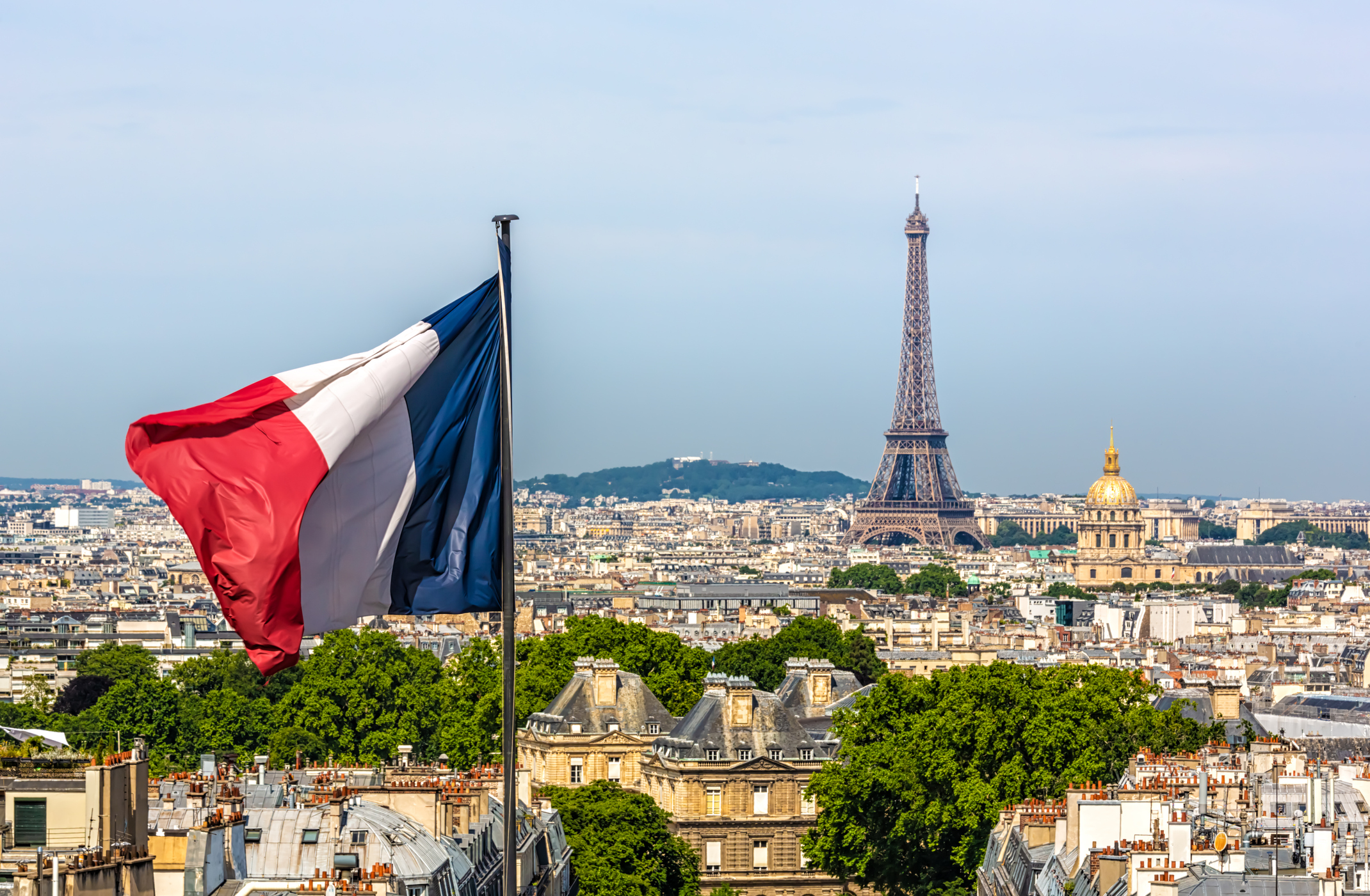 French flag over Paris skyline