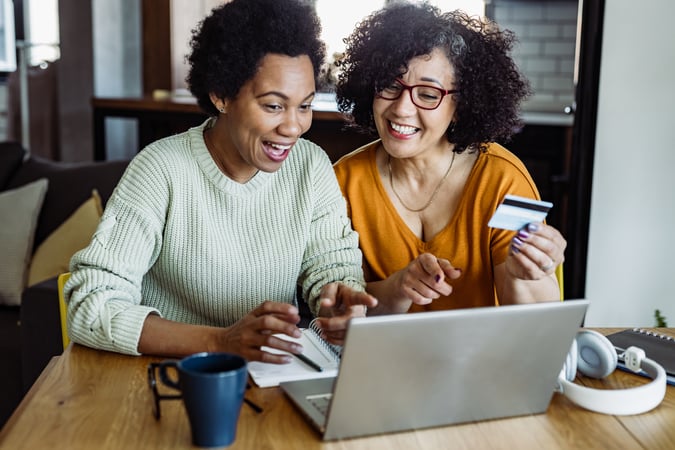 Two happy women online shopping