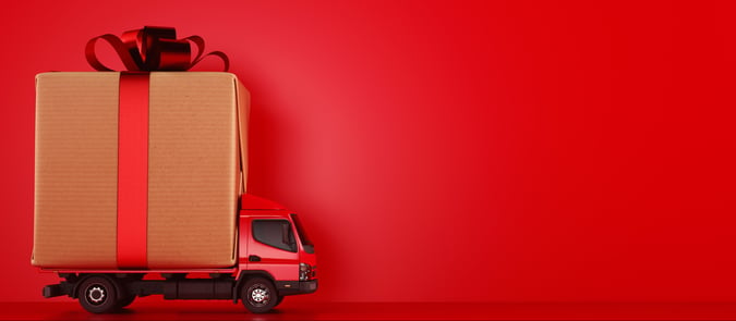Mini red lorry carrying Christmas gift