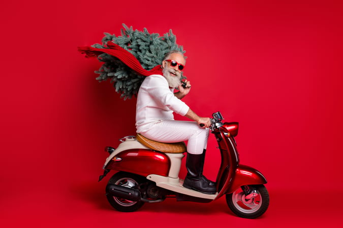 Modern Santa on motorbike with Christmas tree