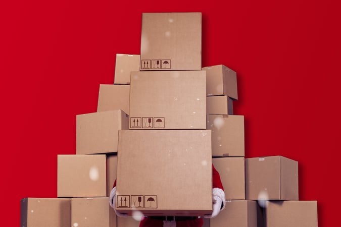 Santa hidden behind cardboard boxes