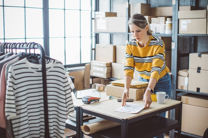 woman-picking-up-parcel-in-room-of-parcels