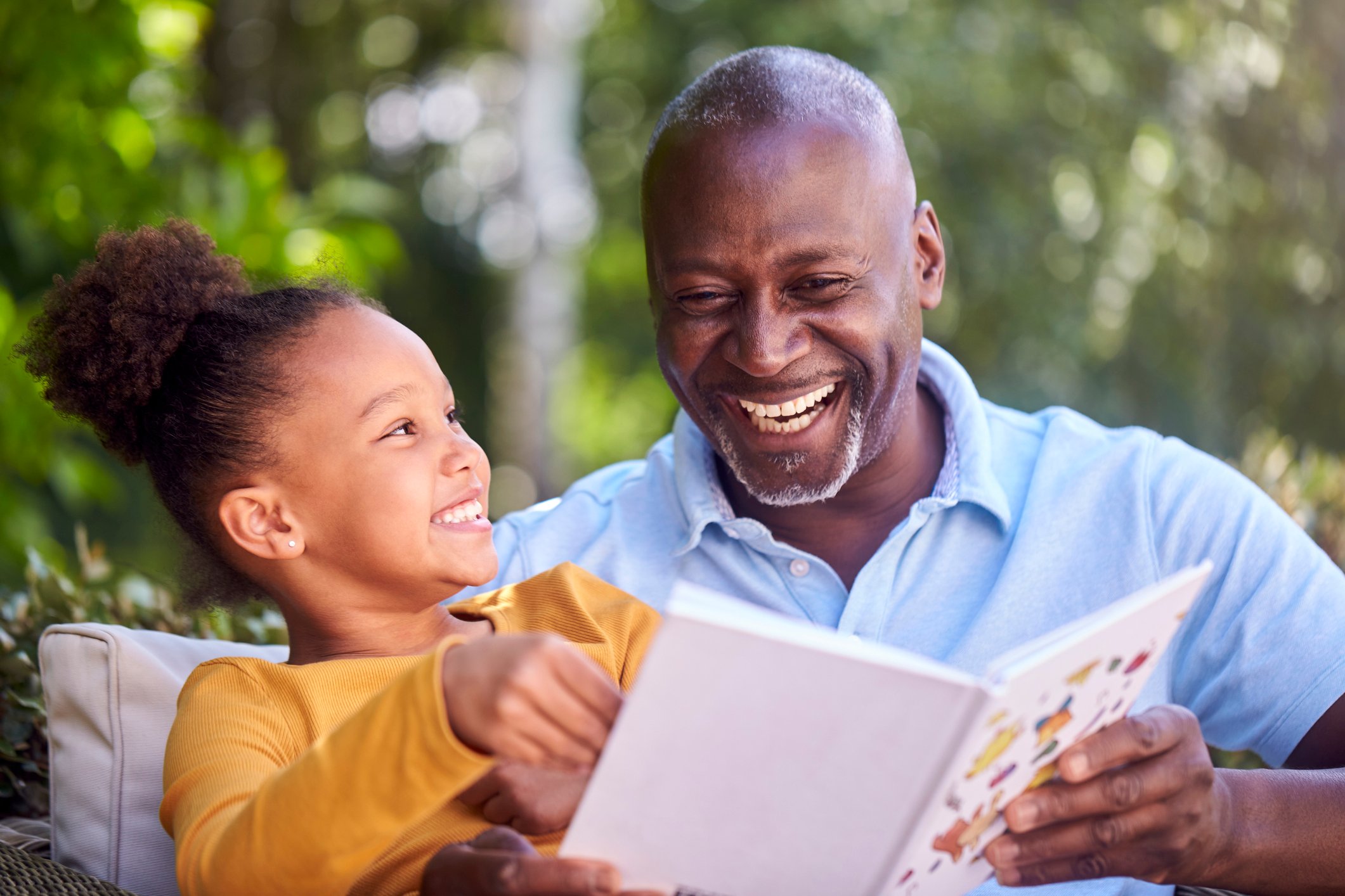 Man and daughter reading a book