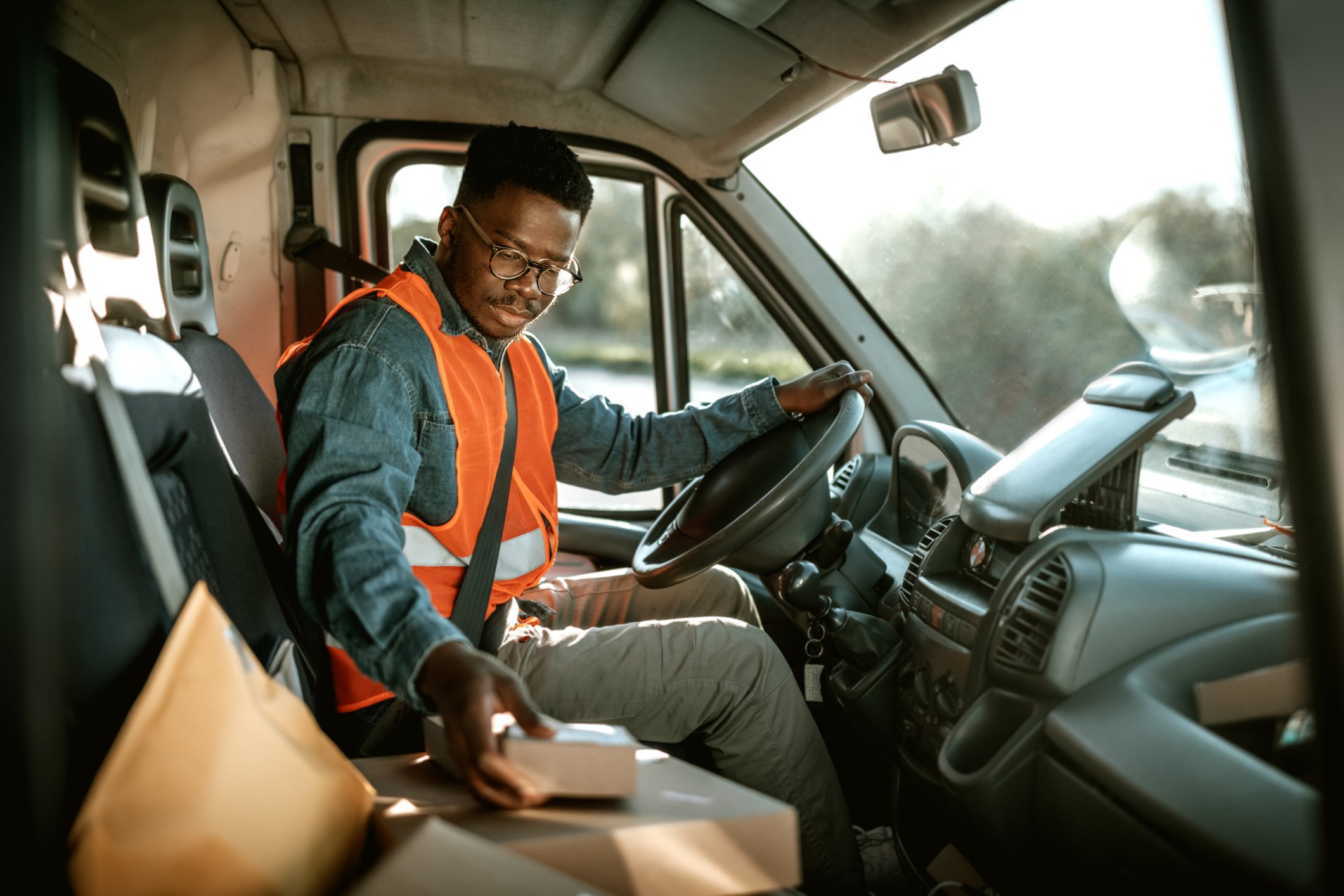 delivery driver with parcels in van