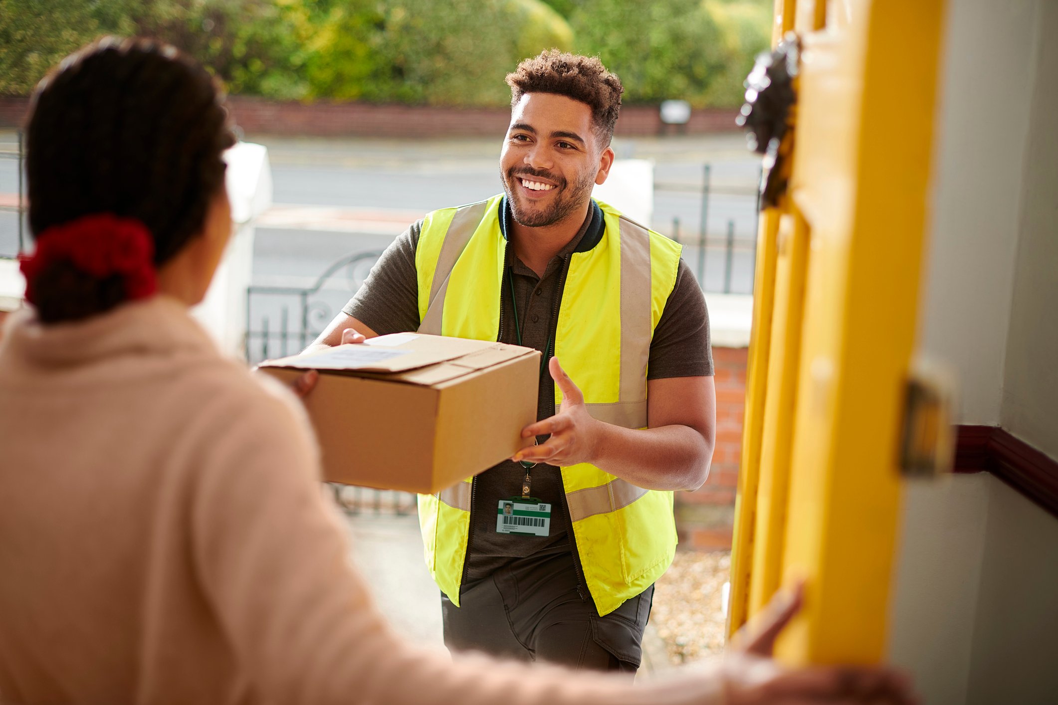 delivery person handing parcel to customer