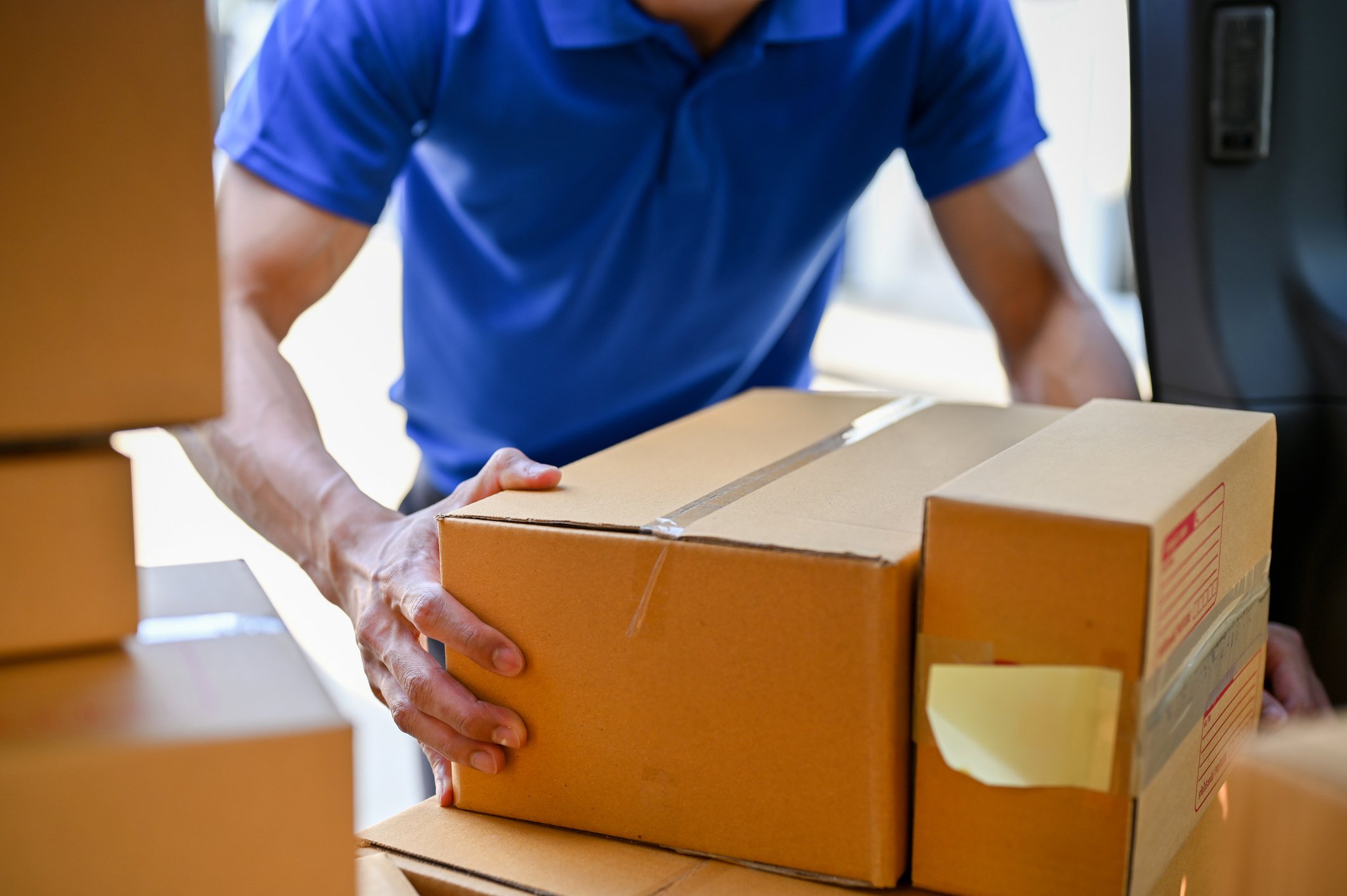 delivery person about to pick up multiple parcels