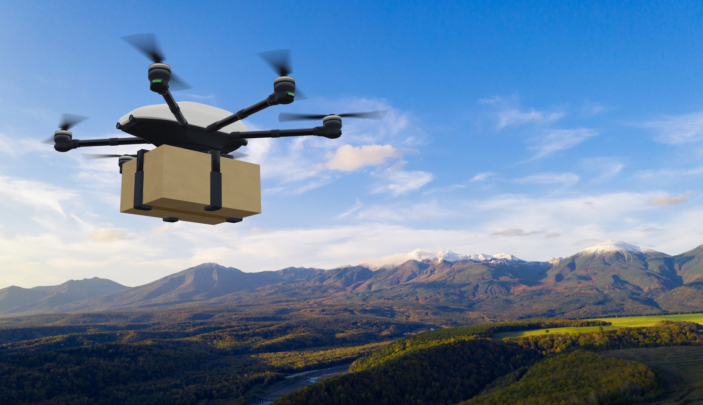 drone delivering a parcel over mountains