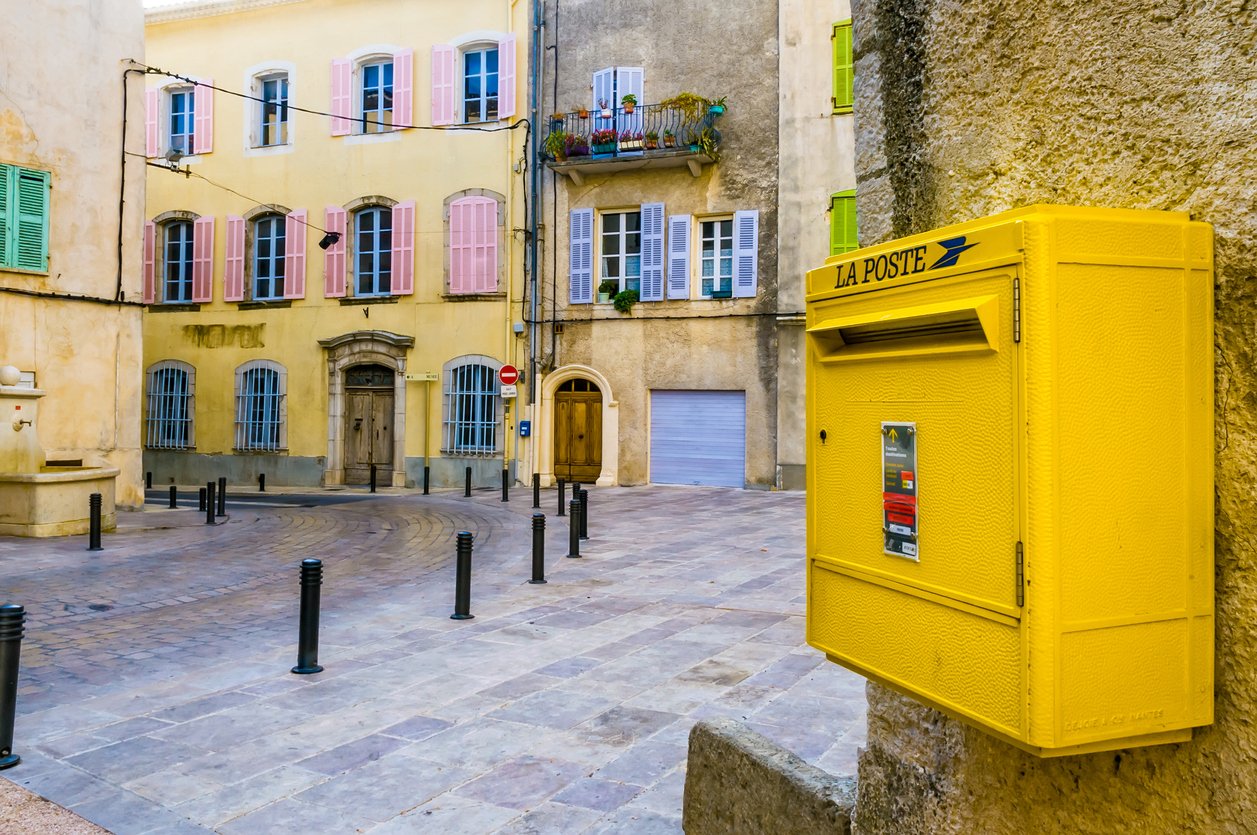 Yellow French post box with 'La Poste' written on it