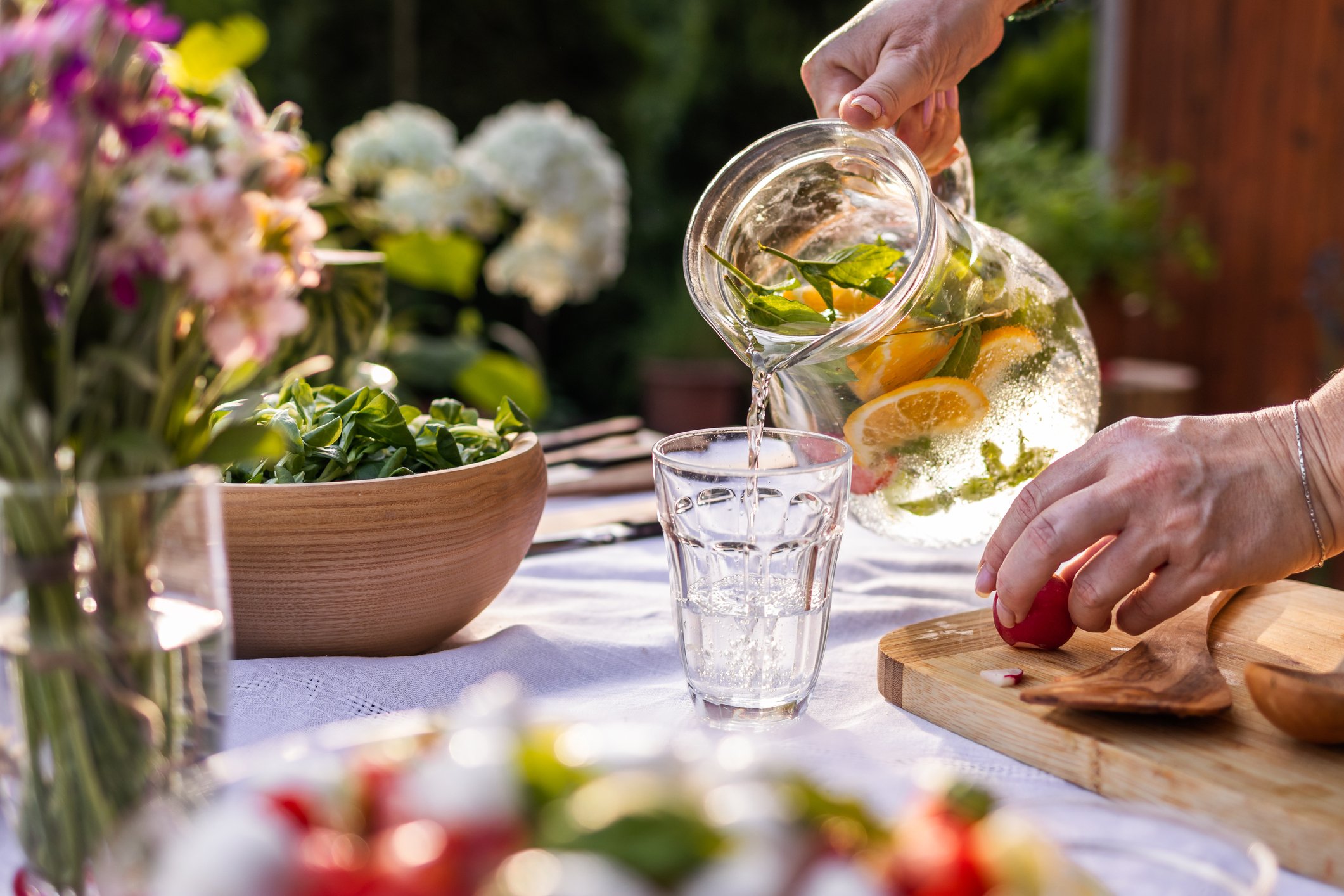 Woman pouring lemonade in garden