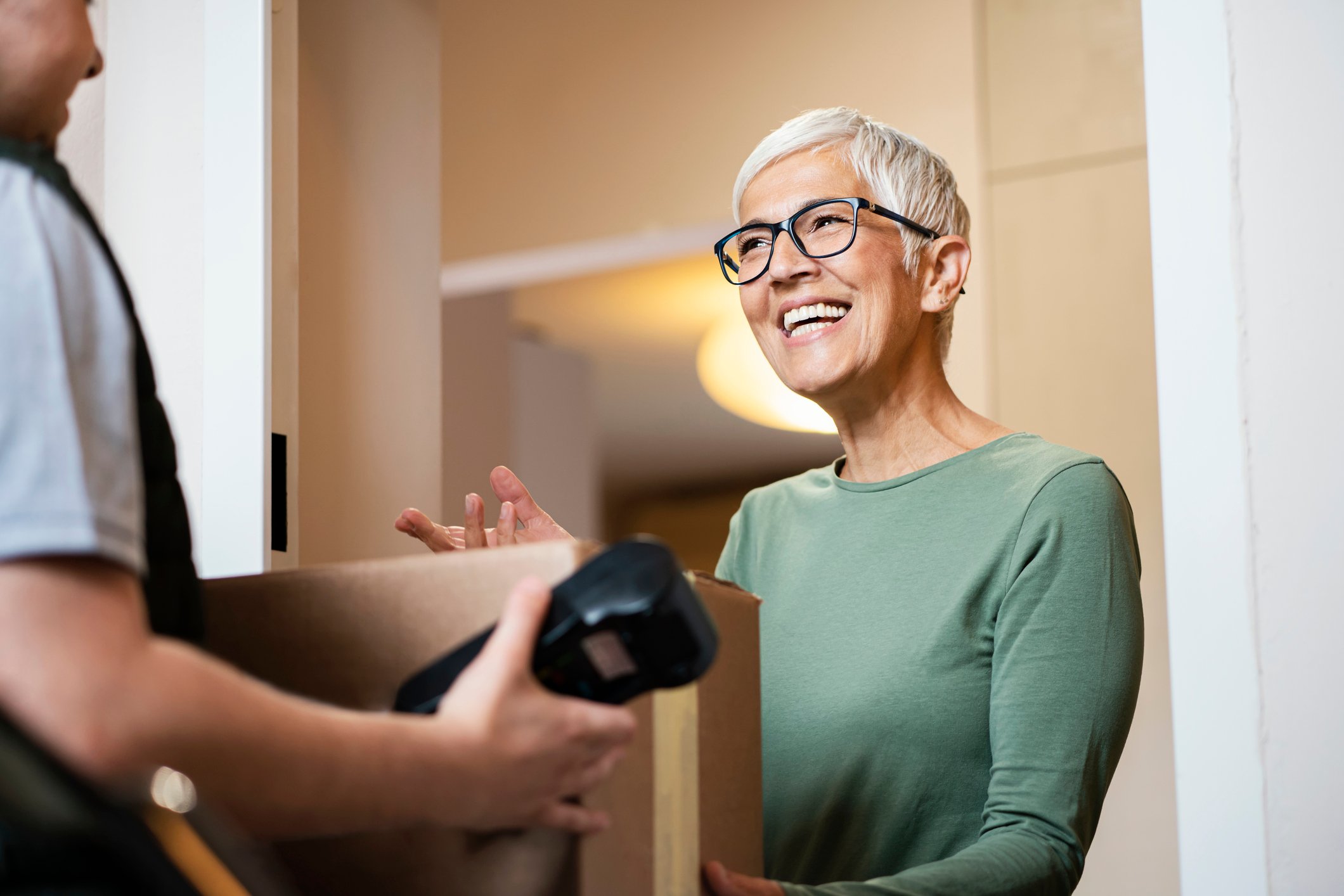 Woman accepting parcel at door