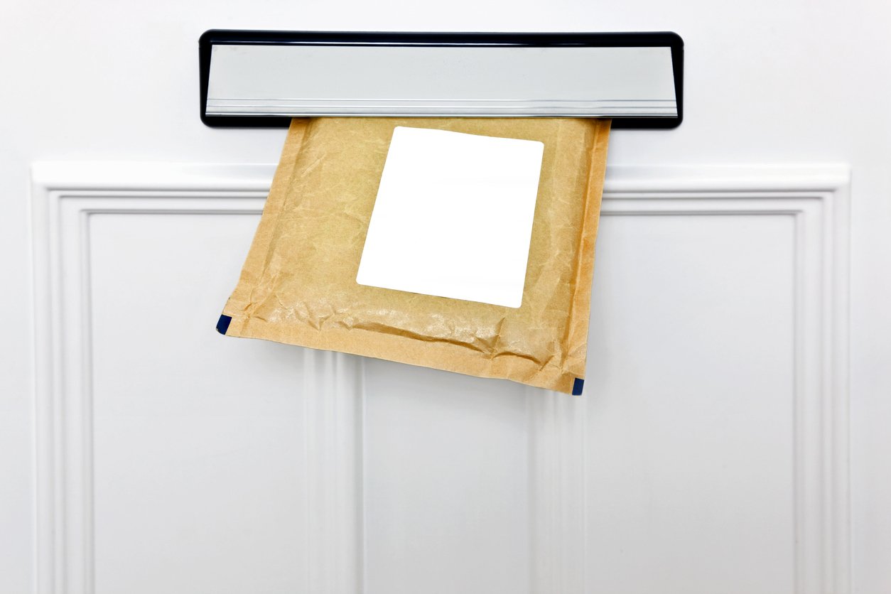 letter being posted through letterbox