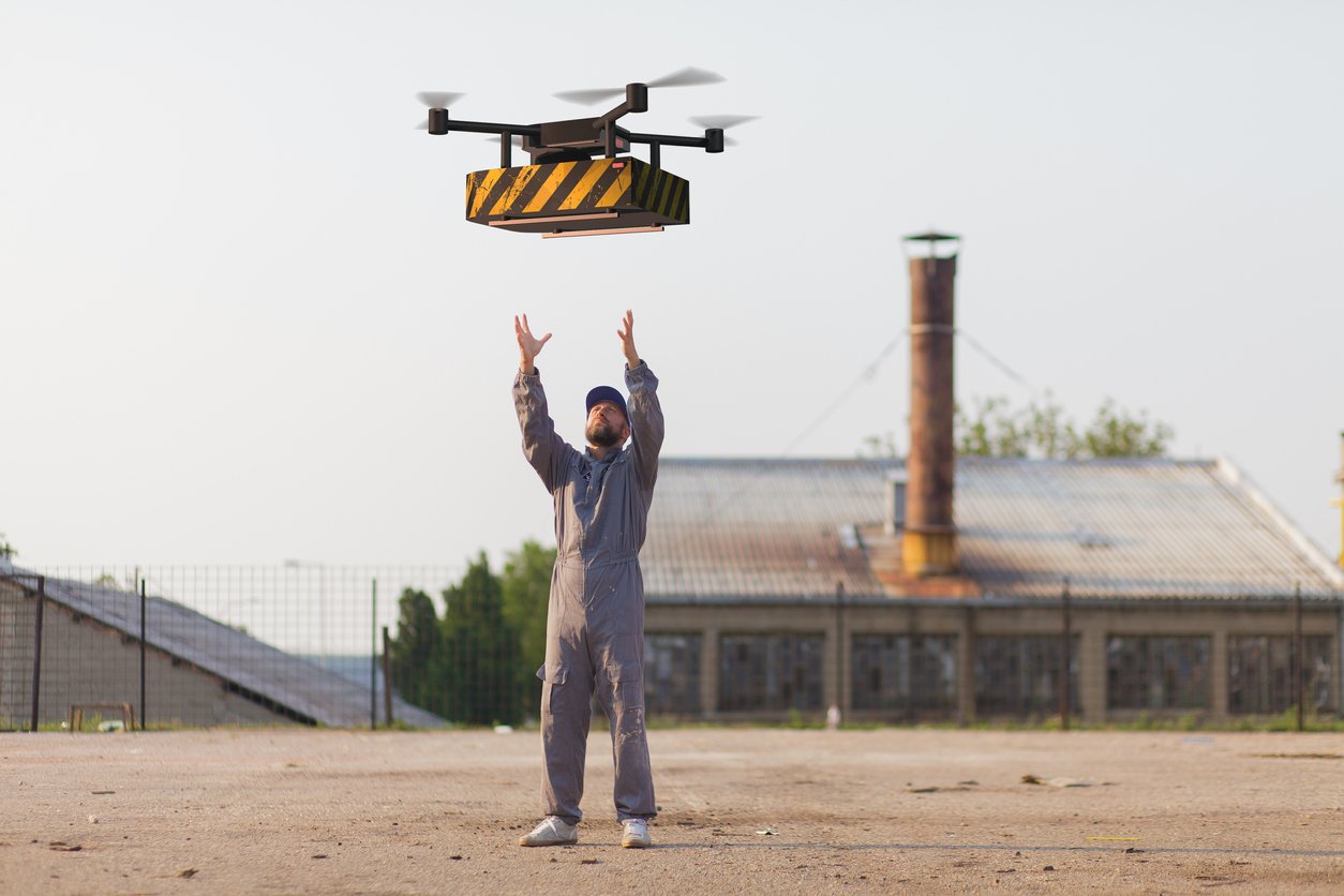 person waiting for parcel to be delivered by drone