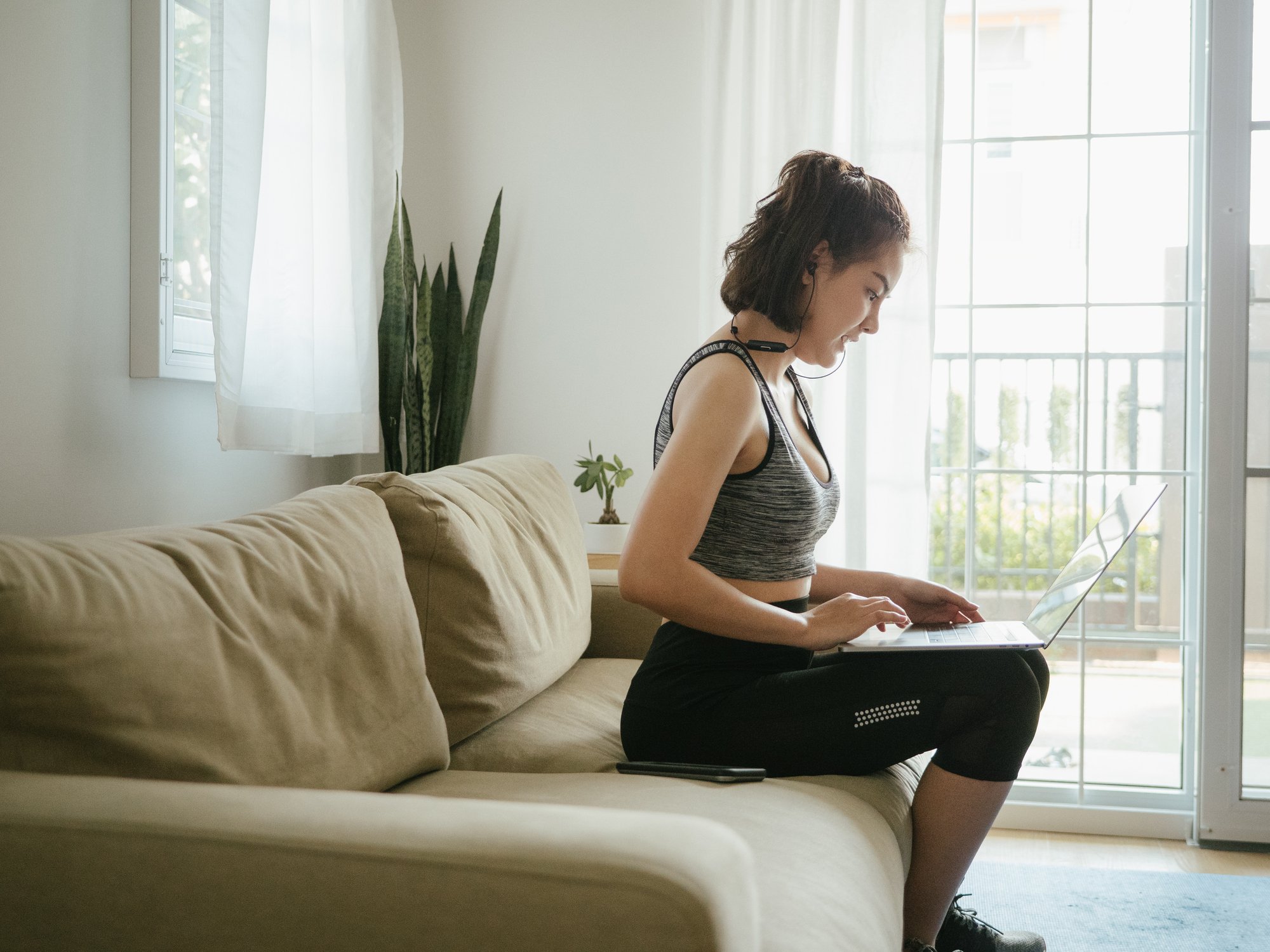 Lady in workout clothes with laptop