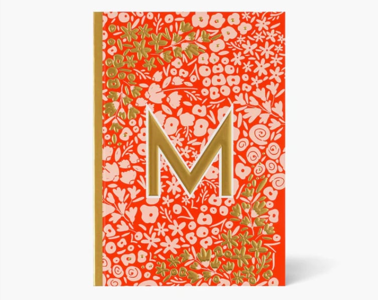 Red notebook with letter 'M' on it