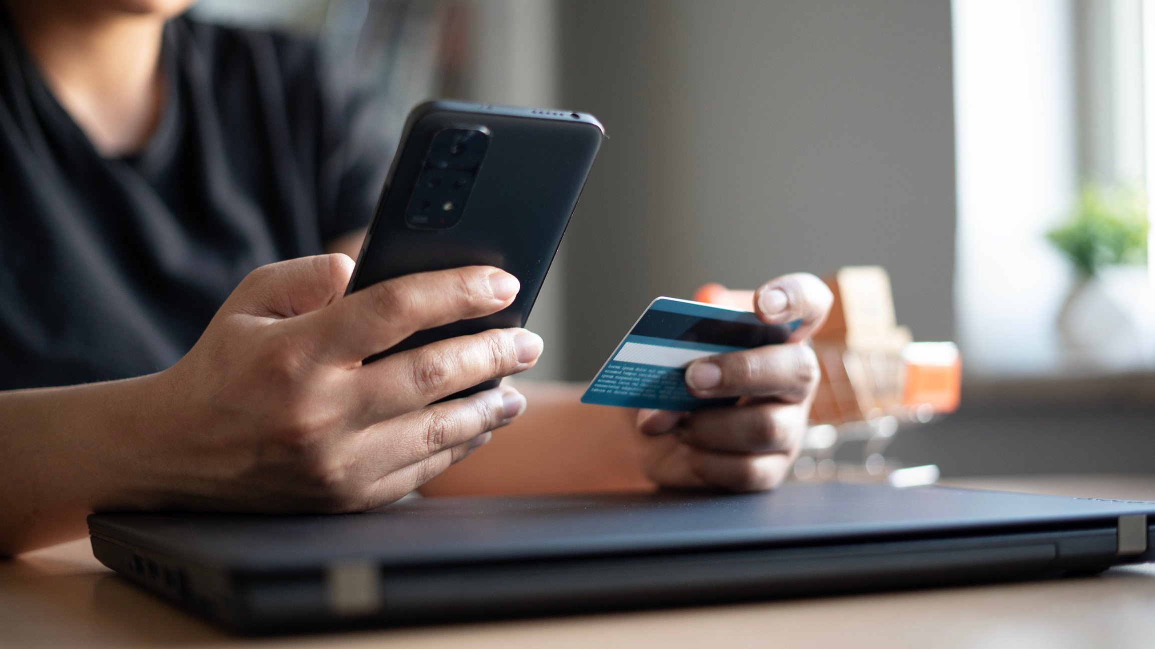 person making purchase on phone using credit card
