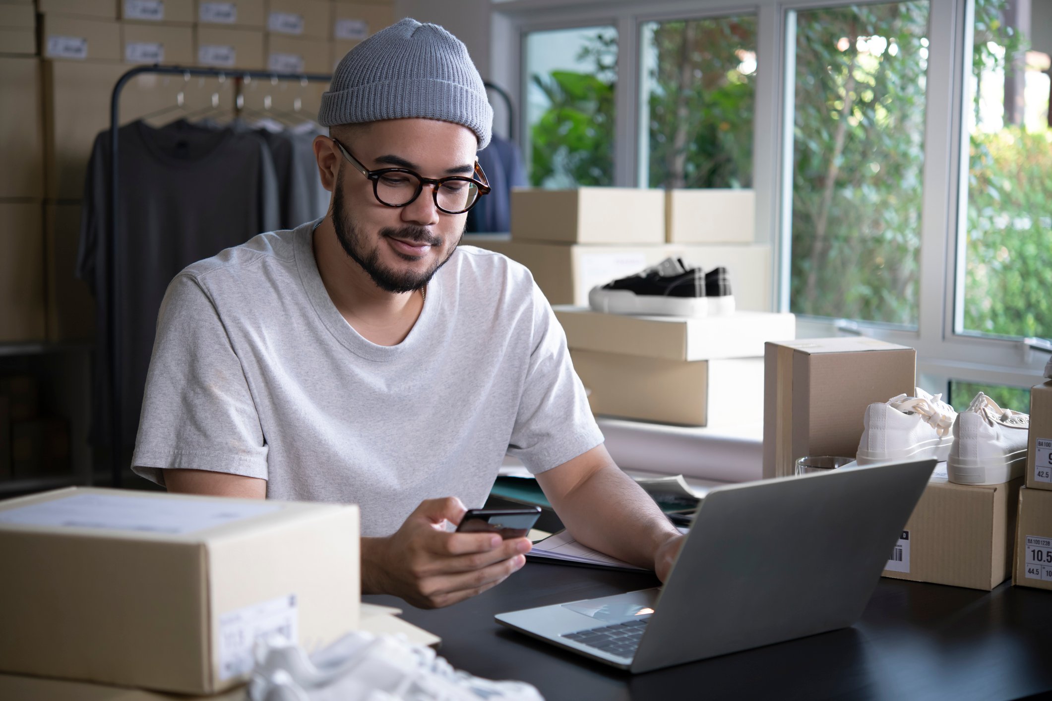 Man on laptop with boxes in background