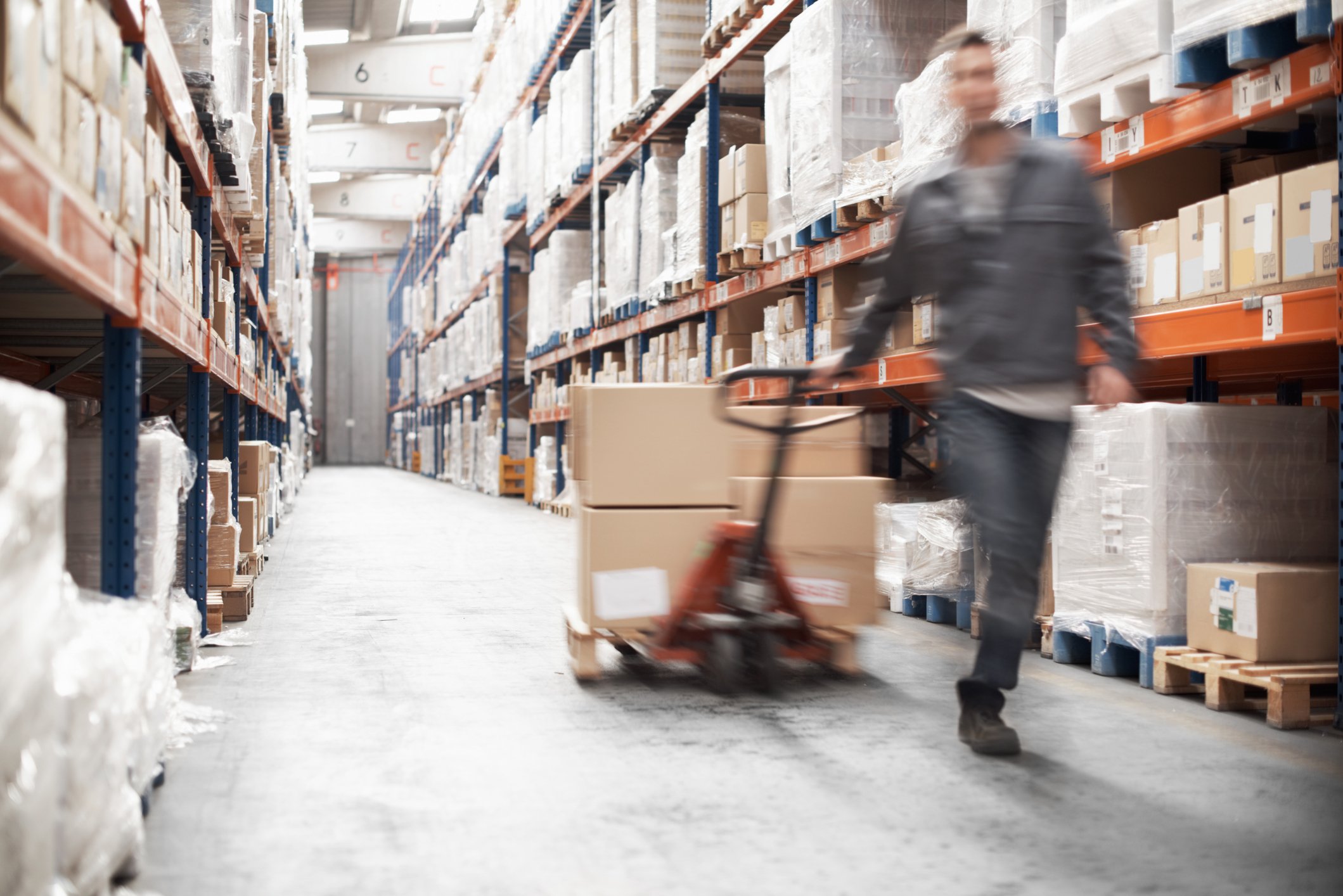 man rushing with stack of parcels