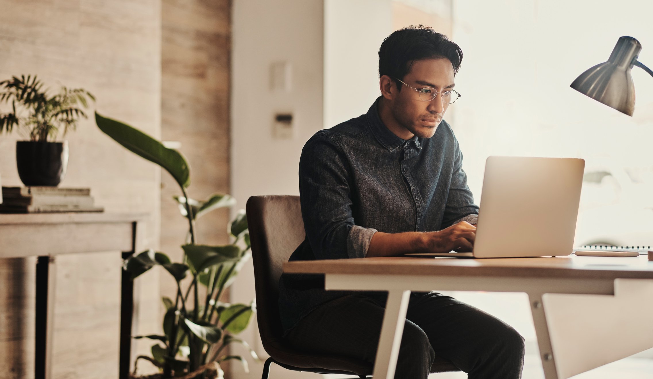 man-sitting-at-table-on-laptop