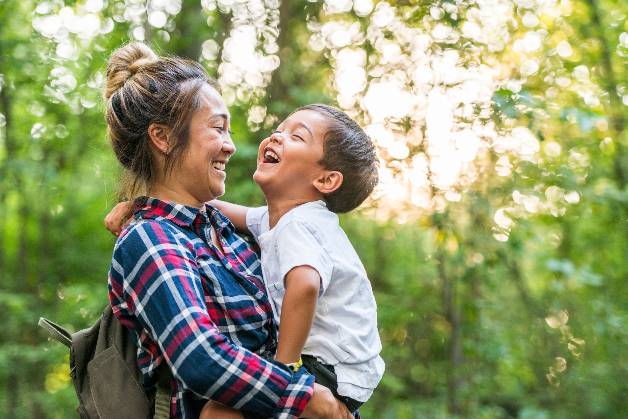 Mother holding son and laughing