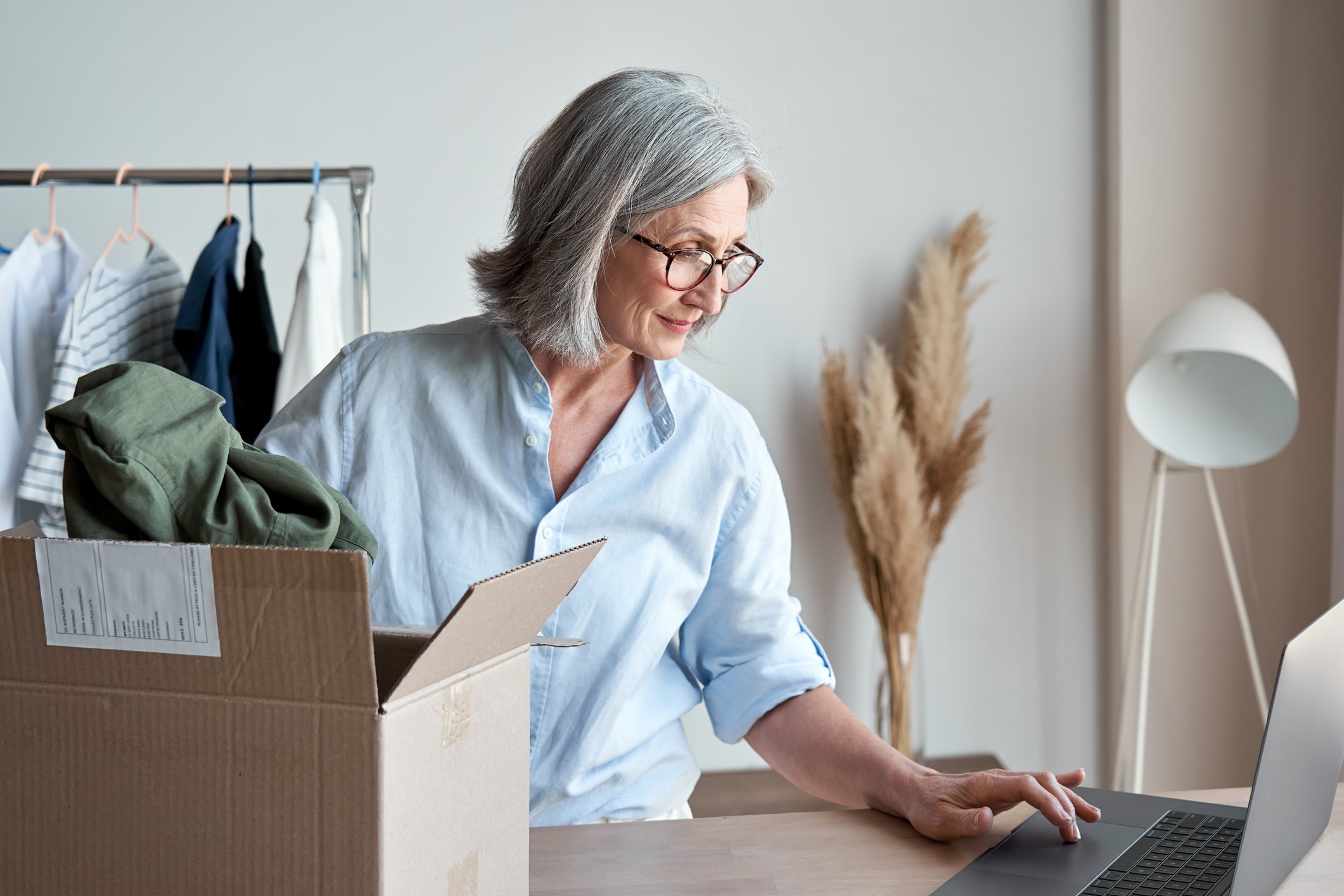 Older woman with box on laptop