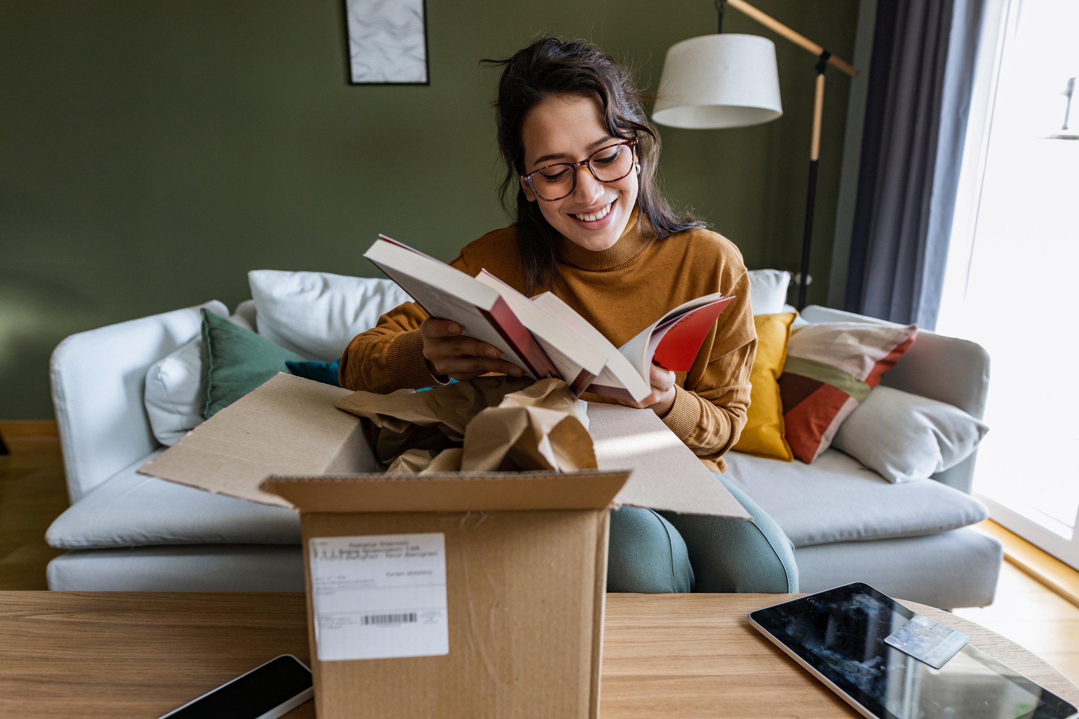 person opening books from parcel