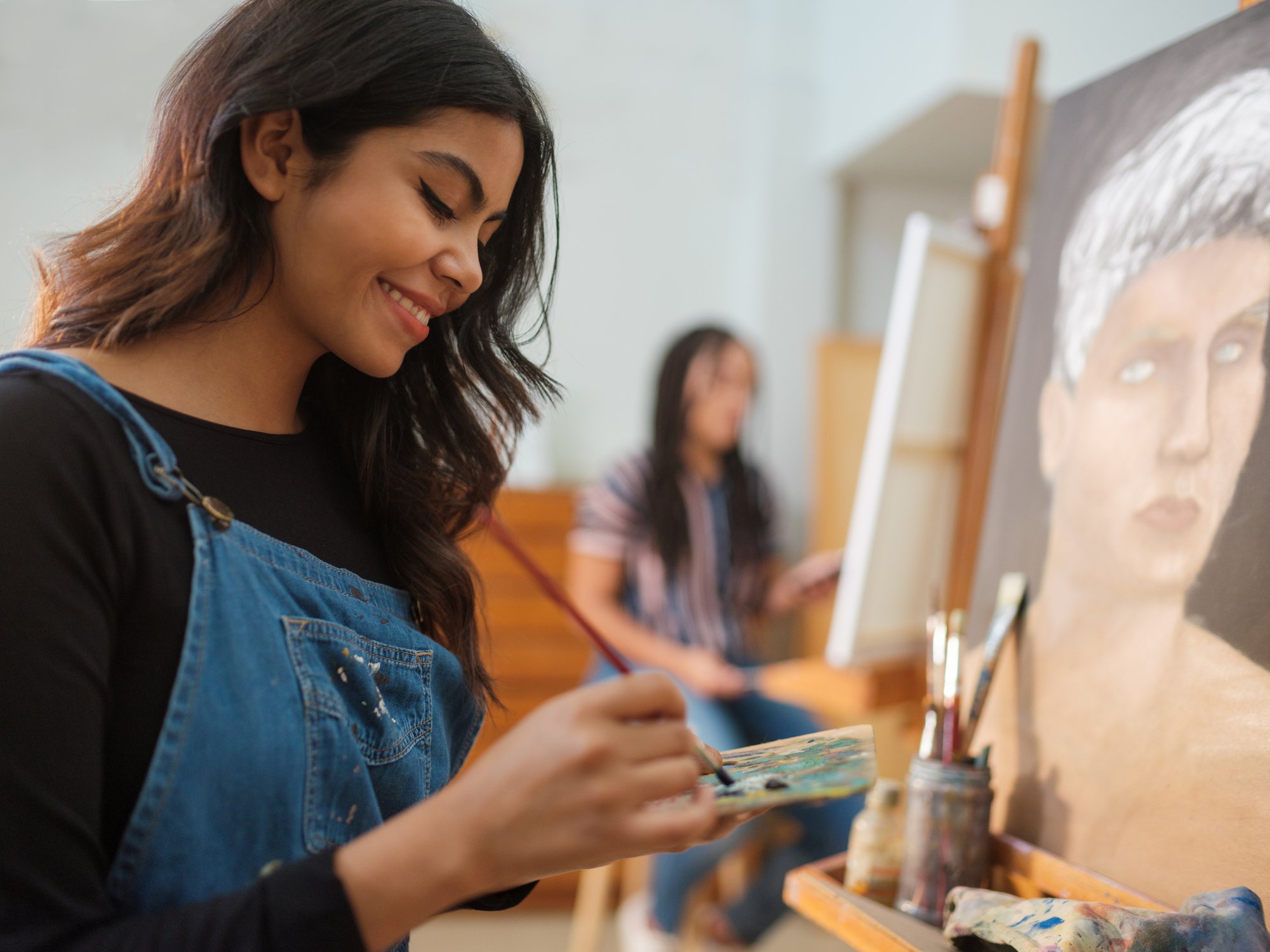 Woman smiling as she paints