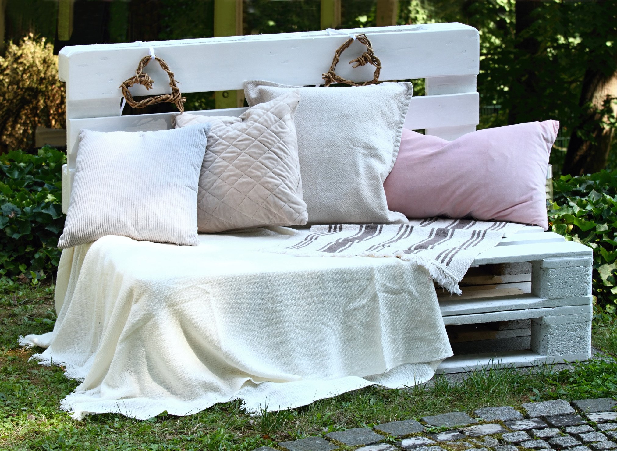 White garden bench  with blankets