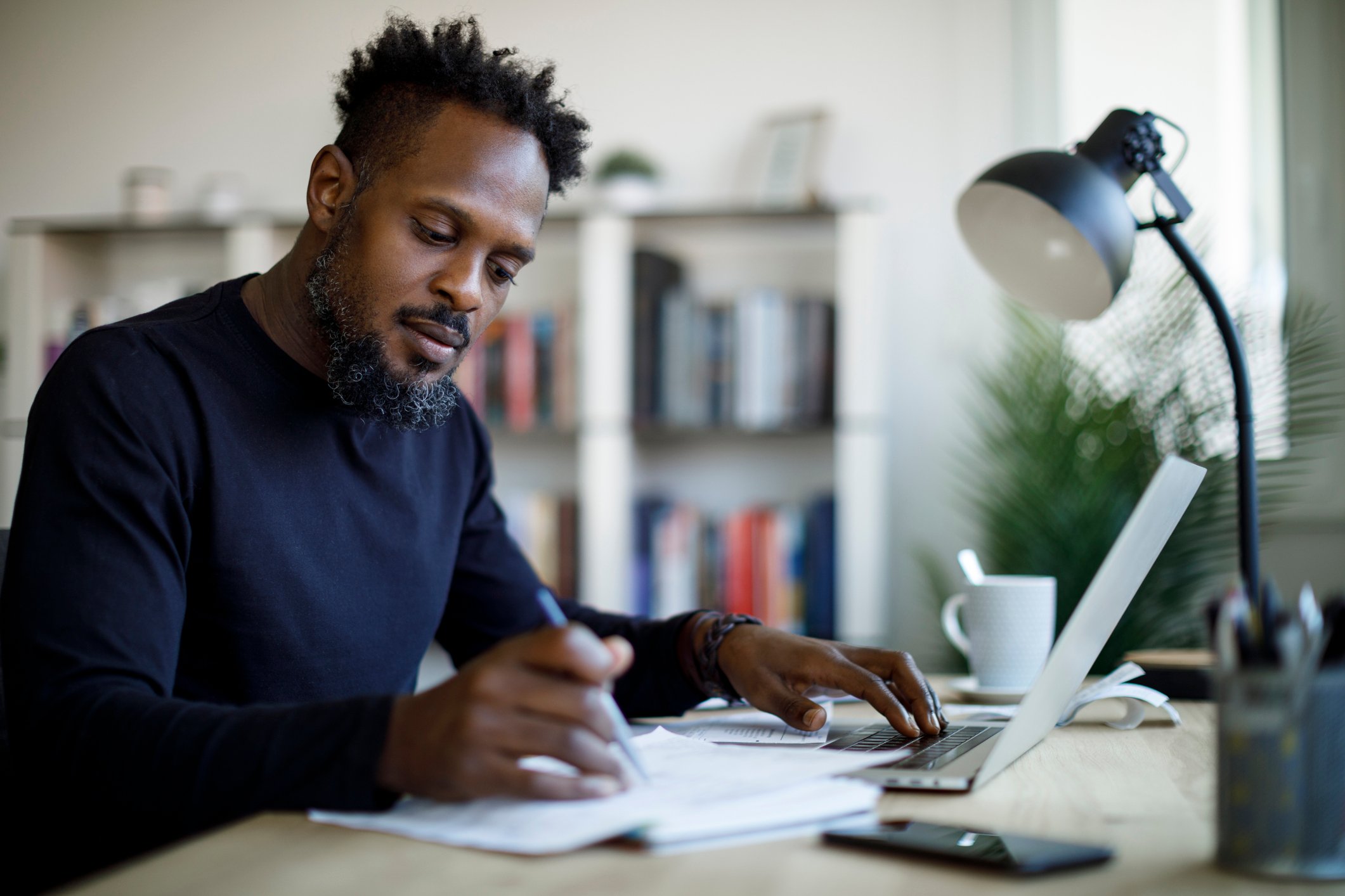 person doing finances with laptop