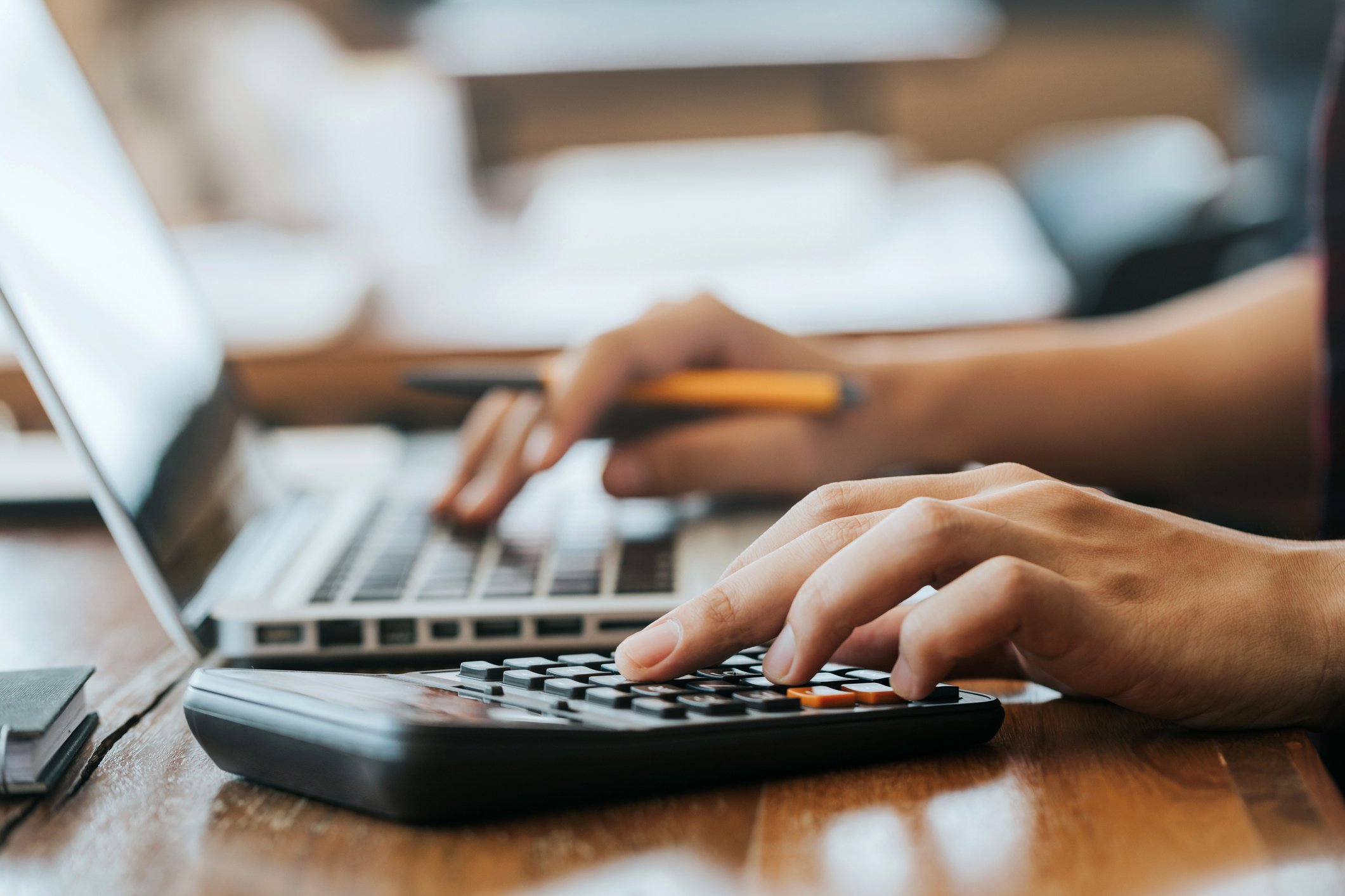 person on laptop with calculator