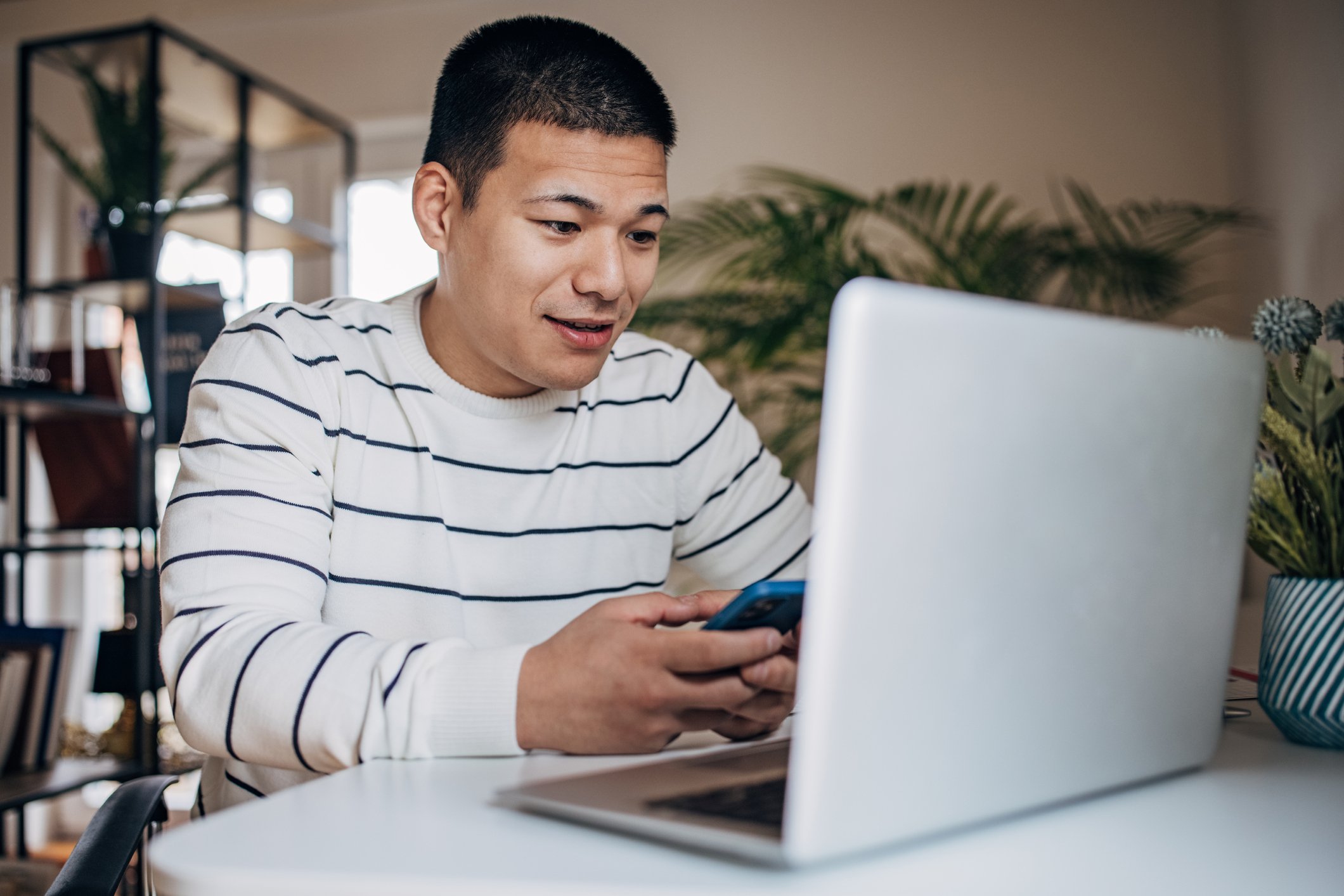 person on phone and laptop