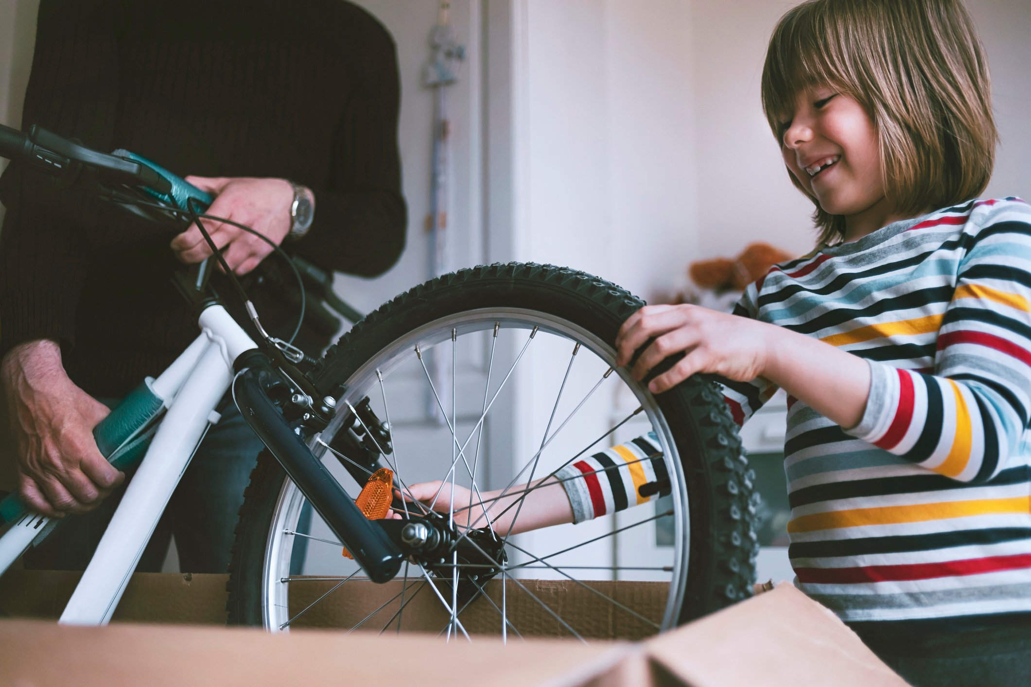 person pulling bike out of box