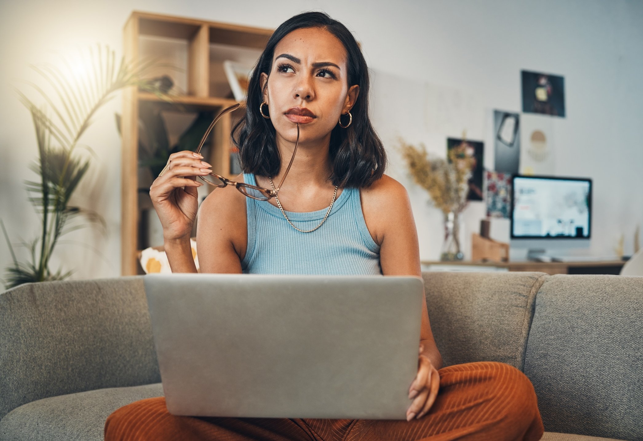 person thinking on laptop