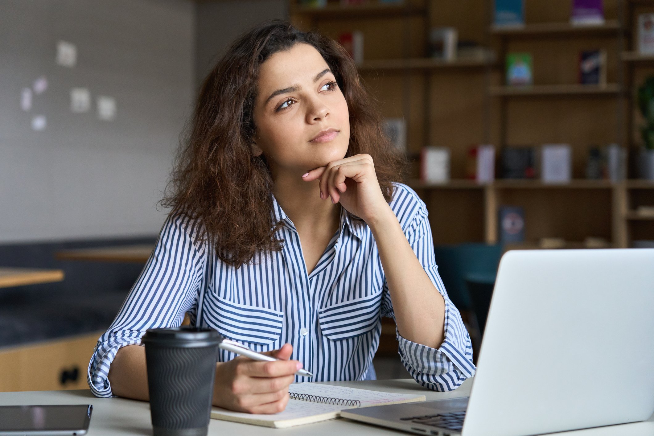 person thinking while on laptop