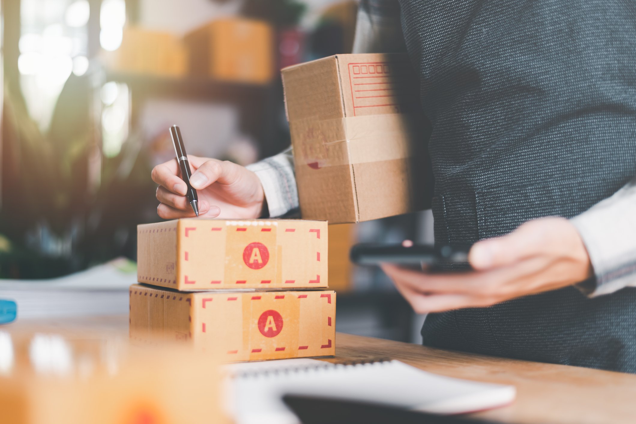 person writing on parcels