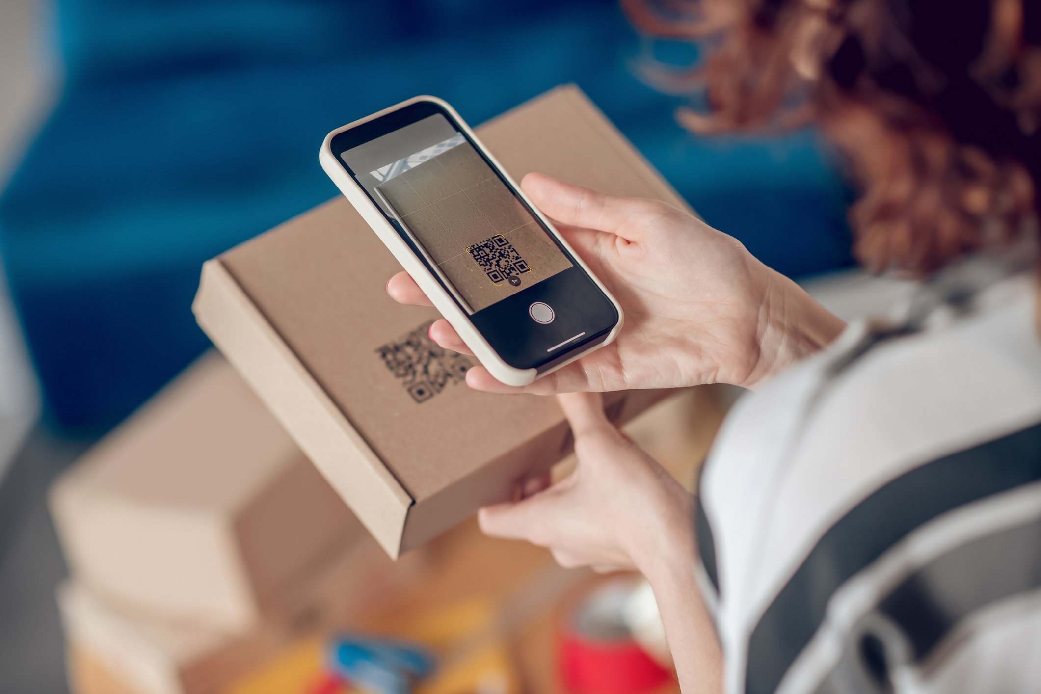 Person scanning QR code on parcel