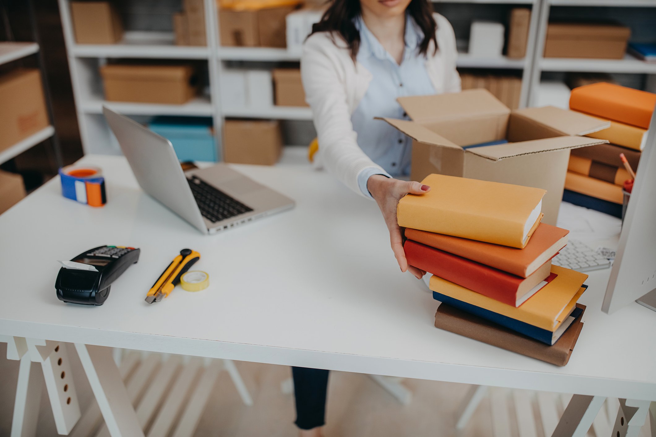 Woman packing books in box