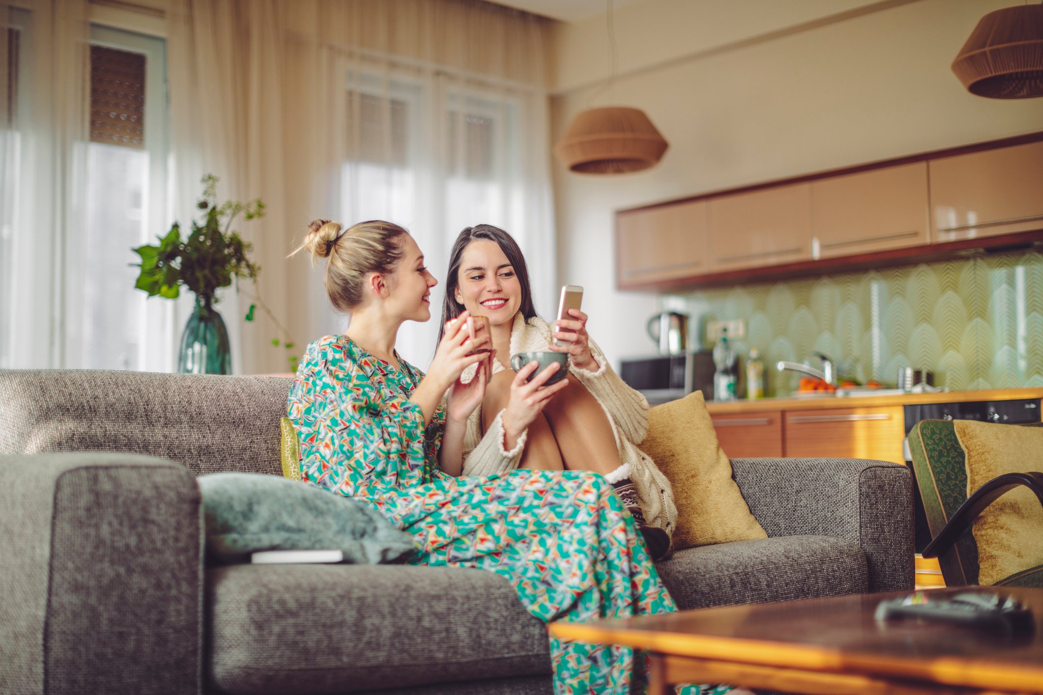 Two friends shopping on phone