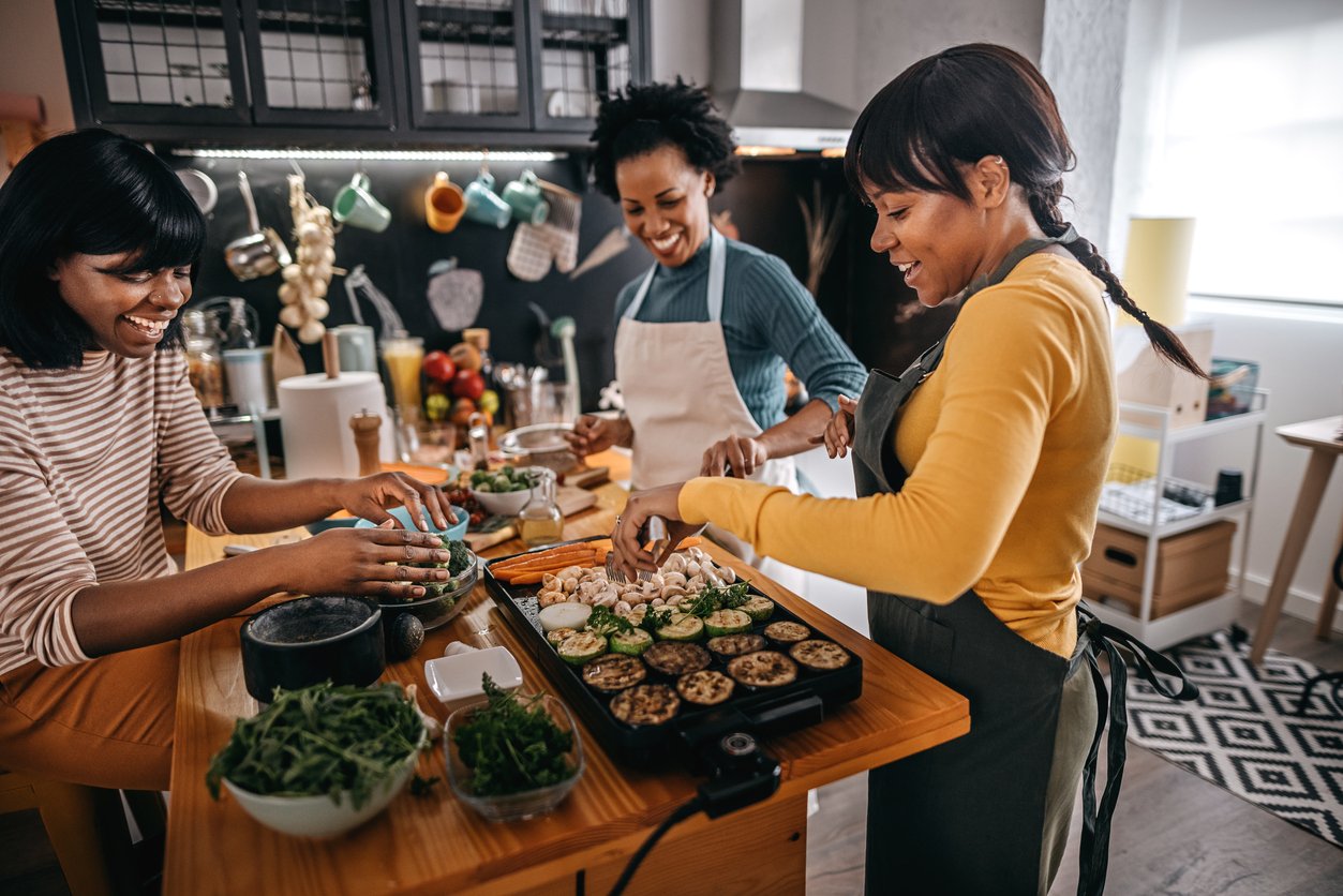 3 women cooking Thanksgiving food in the kitchen