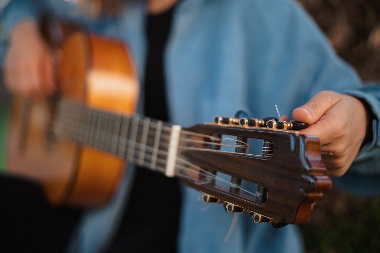 Man tuning a guitar