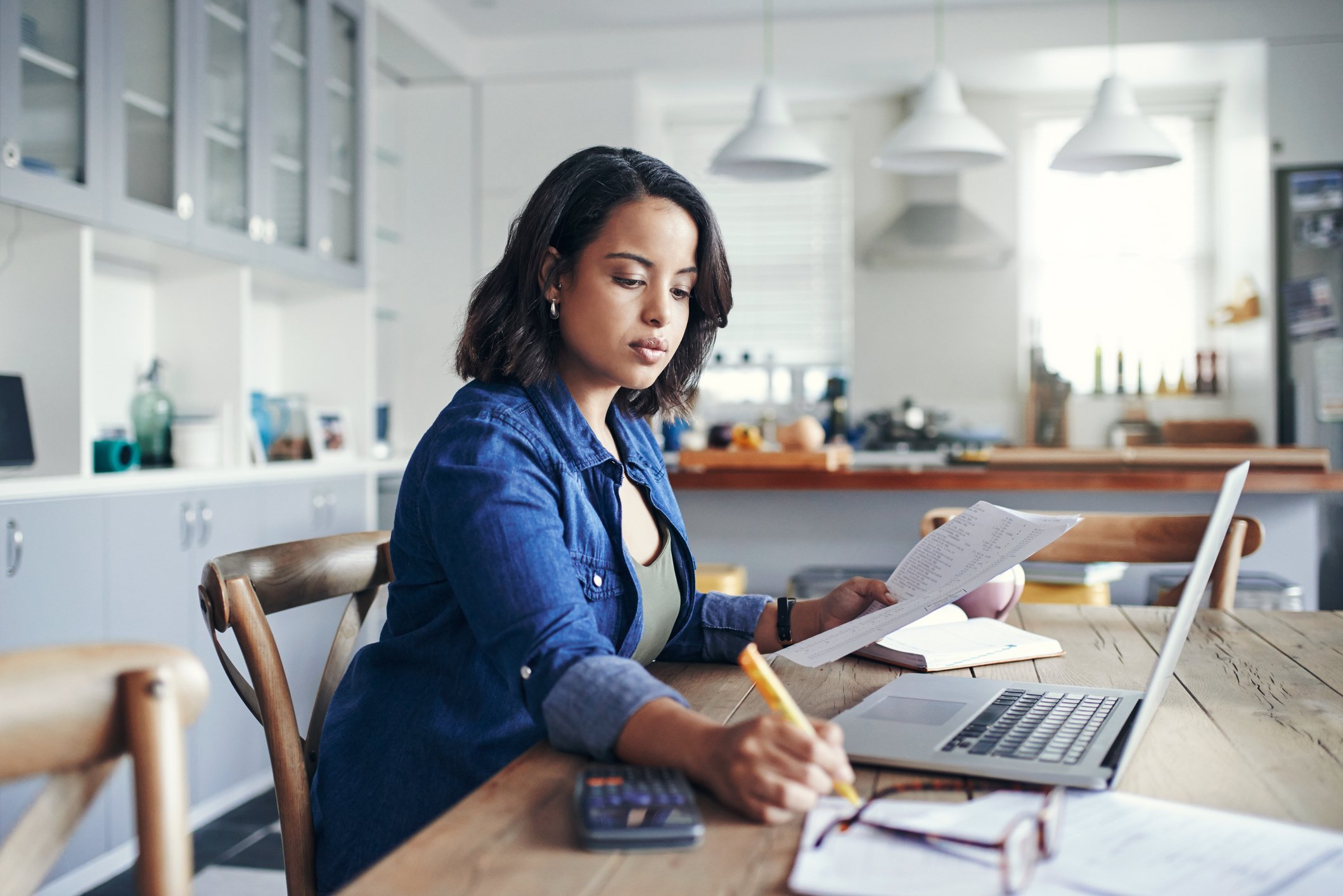 person looking at finances on laptop