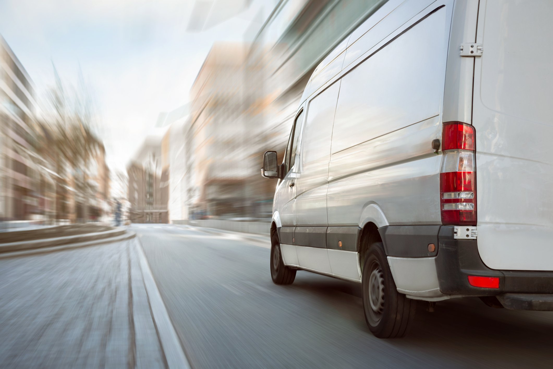 van driving quickly down road