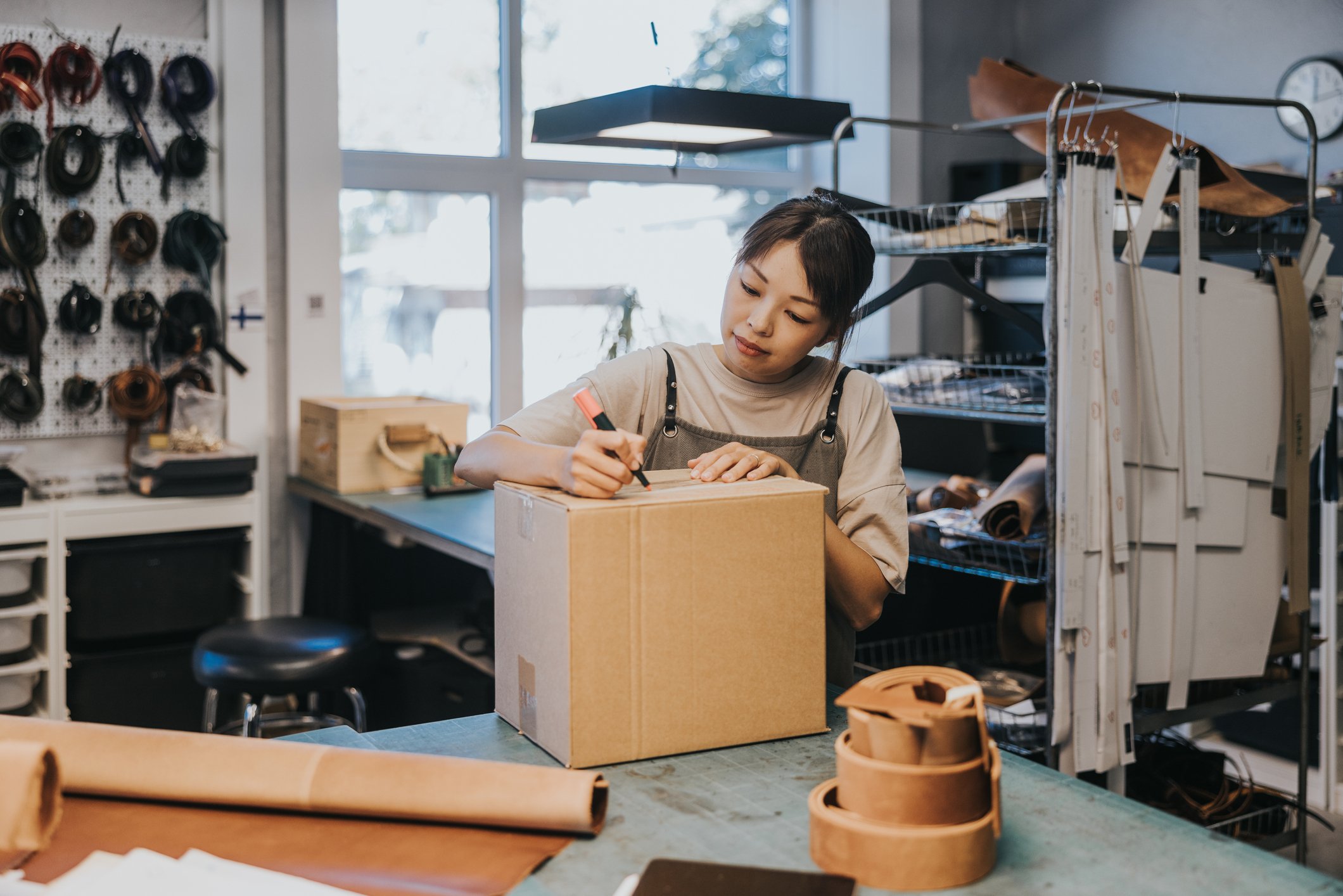 woman preparing parcel to ship