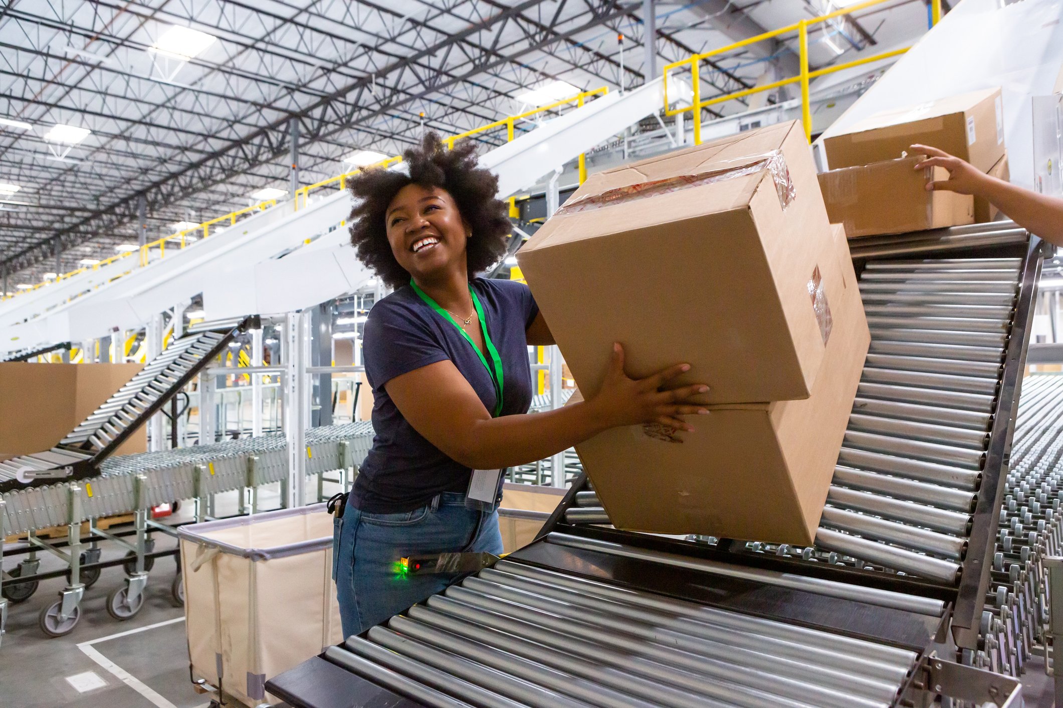 woman in warehouse handling parcel