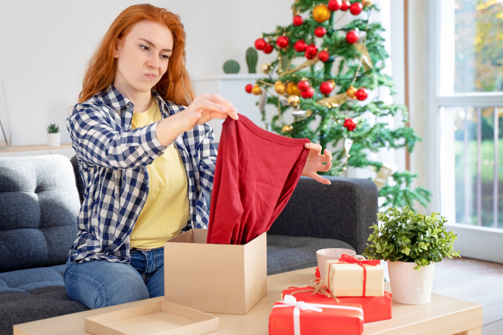 woman looking upset with christmas gift