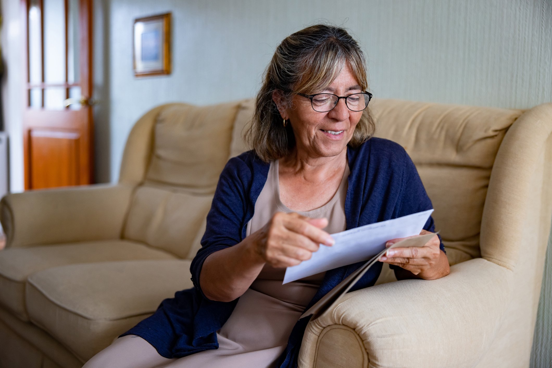 woman-on-couch-holding-letters