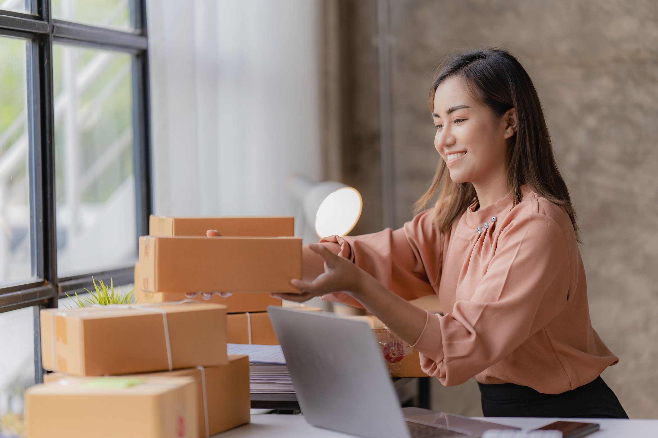 woman stacking parcels on top of each other