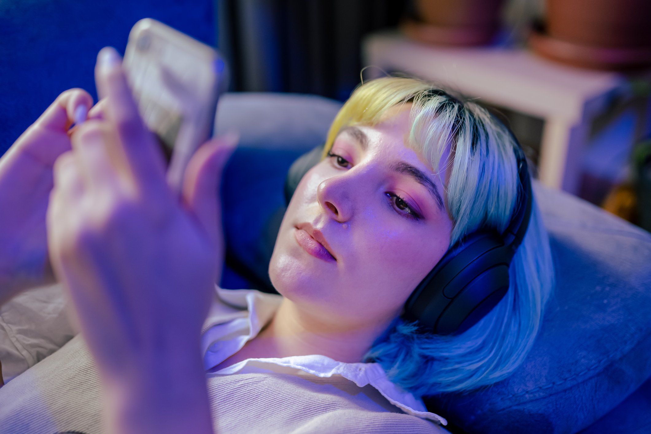 Young woman with headphones on phone