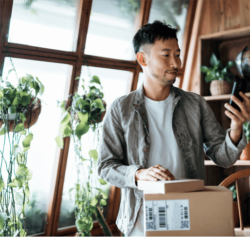 Man looking at phone with parcels